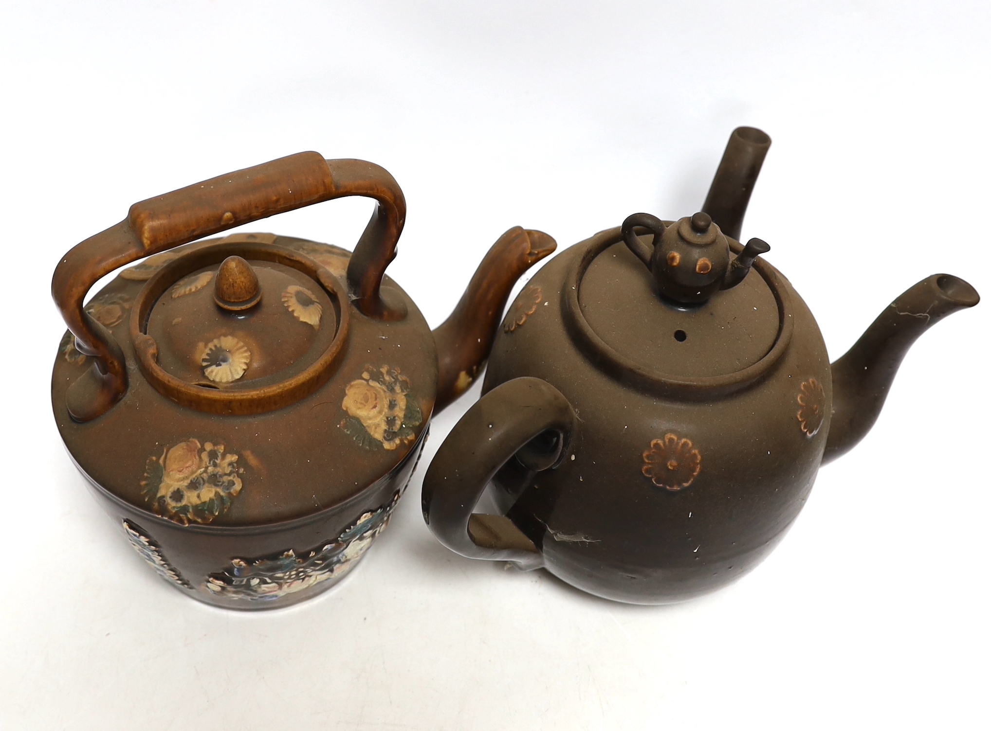 Two Measham Barge ware glazed pottery teapots, decorated in relief, largest 24cm wide